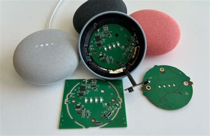 Google Nest Minis lined up on a wall
